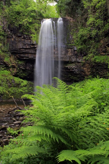 Waterfall flowing over faulted edge of hard sandstone