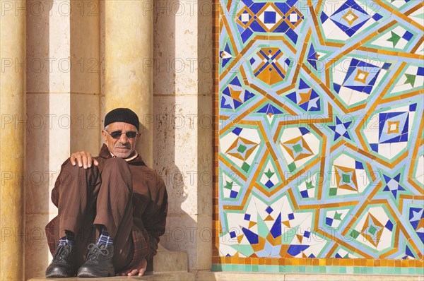 Man sitting inside the Hassan II Mosque in Casablanca