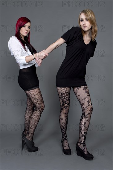 Two young women wearing short dresses