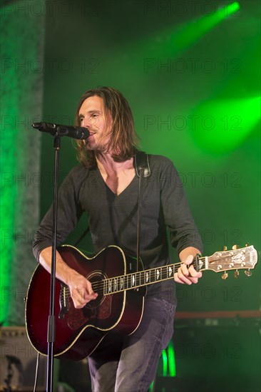 Lead singer and frontman Adrian Sieber from the Swiss pop band Lovebugs performing live in the Schueuer concert hall