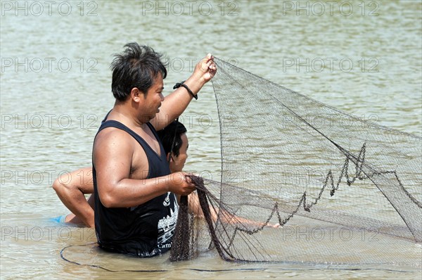 Fishermen putting out a fishing net in the Sangkae river