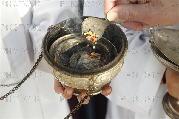 Frankincense being scattered in a censer