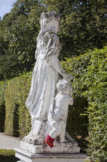 Baroque statue wearing a red hand-knitted sock in front of the Electoral Palace in Trier