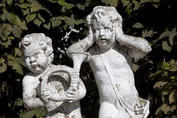 Statues of baroque musicians in the palace gardens in front of the Electoral Palace