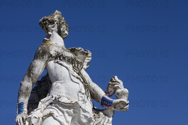 Baroque statue wearing a hand knitted wrist warmer in front of the Electoral Palace in Trier