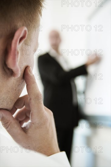 Speaker explaining something on a flip for his audience during a training