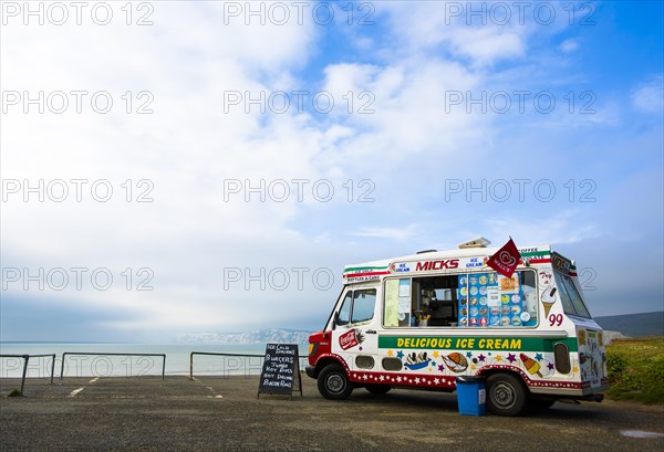 An ice cream van is parked on a coastal car park above Compton Bay on the Isle of Wight