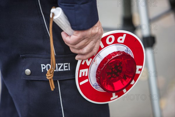 Policeman holding a signalling disc