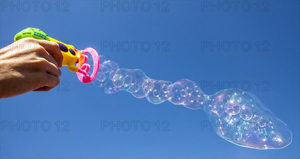 Smaller soap bubbles enclosed in larger bubbles from a bubble machine