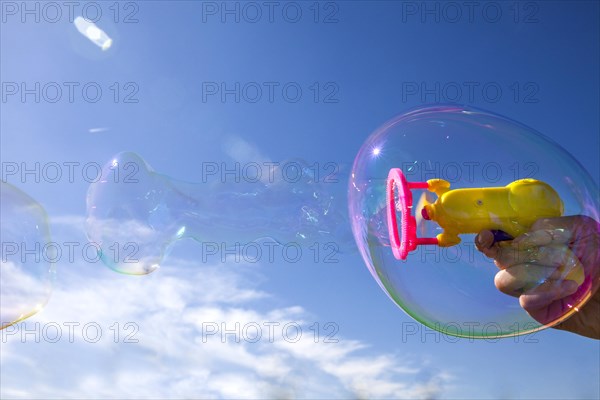 Smaller soap bubbles enclosed in larger bubbles from a bubble machine