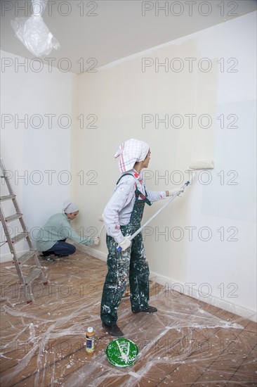 Mother and daughter renovating a room