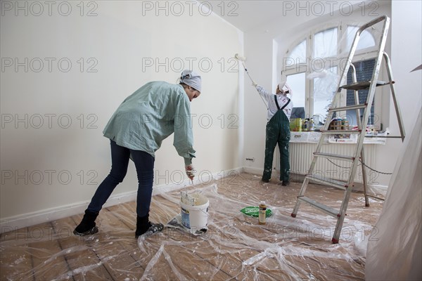 Mother and daughter renovating a room