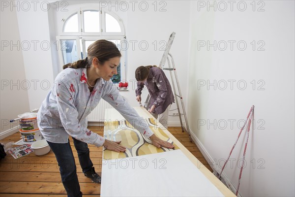 Mother and daughter renovating a room