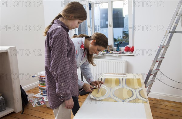 Mother and daughter renovating a room