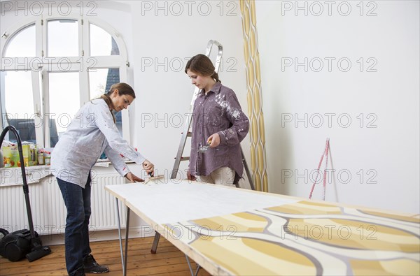 Mother and daughter renovating a room