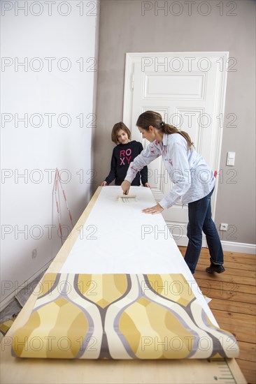 Mother and daughter renovating a room