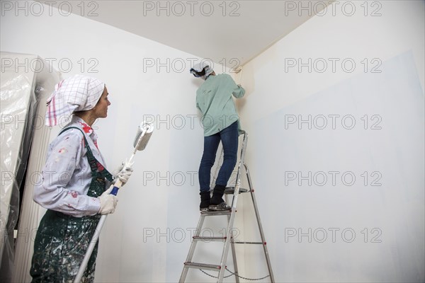 Mother and daughter renovating a room