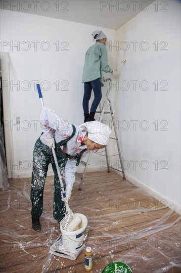 Mother and daughter renovating a room