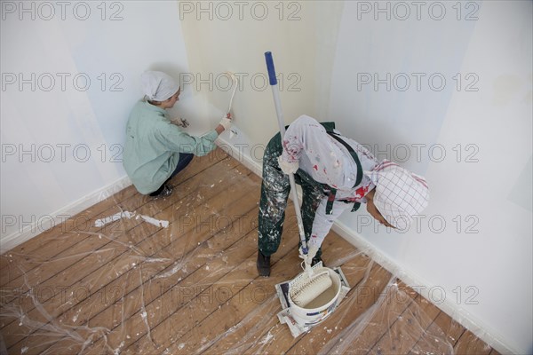 Mother and daughter renovating a room