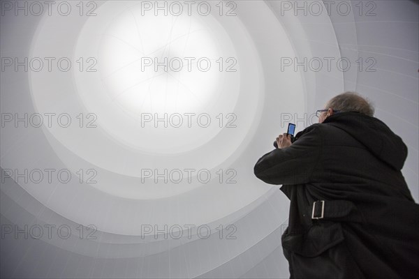 Visitor taking a picture of an installation by Christo