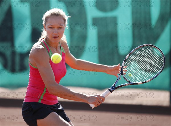 Young woman playing tennis in a holiday club