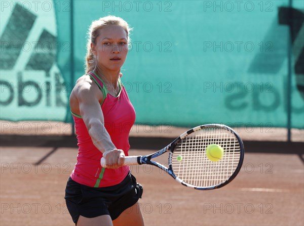 Young woman playing tennis in a holiday club