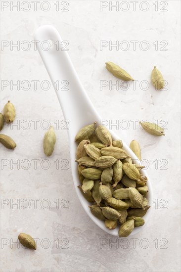 Cardamom pods on a spoon