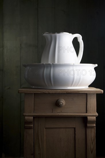 Antique porcelain basin on a small chest of drawers