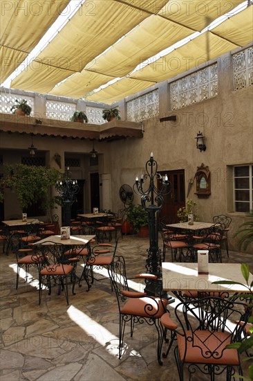 Restaurant in an inner courtyard with an awning