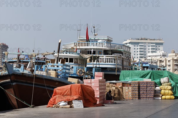 Cargo in front of an old wooden cargo ship