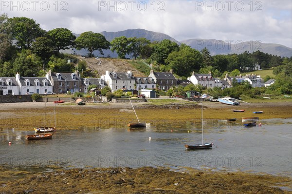 Boats grounded at low tide in a small fishing village