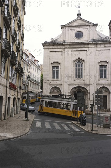 Three trams near a church