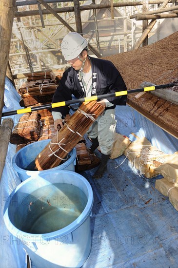 Cypress bark is soaked in water prior to thatching