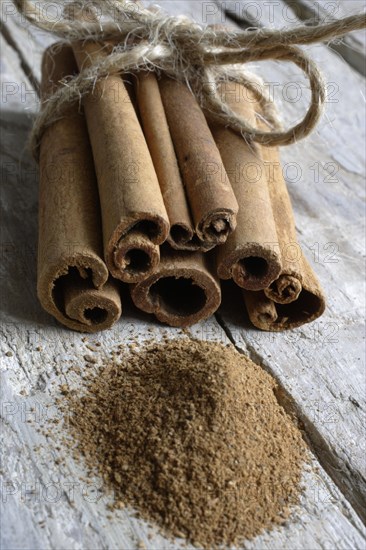 Cinnamon sticks and ground cinnamon on wooden boards