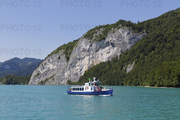 Passenger ship Zwoelferhorn in front of rock wall of Falkenstein