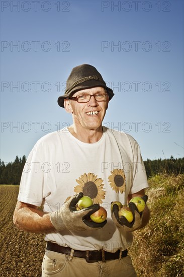 Man with apples on the field