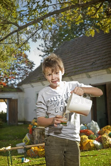 Boy with freshly squeezed apple juice