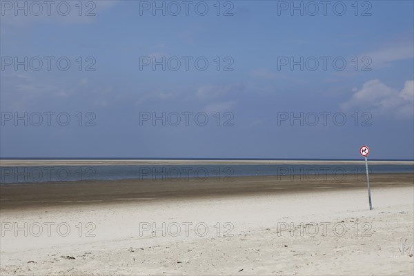 Deserted beach with a dogs prohibition sign on the island of Langeoog