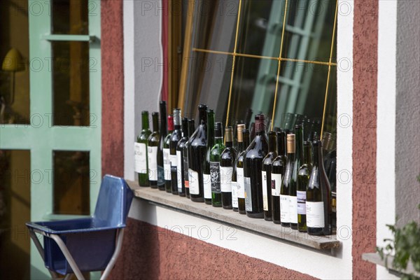 Empty wine bottles on the window sill of a restaurant