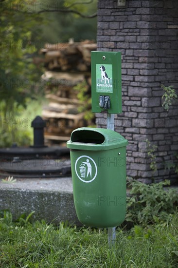 Garbage bin with organic dog waste bags in the Weissensee Nature Park