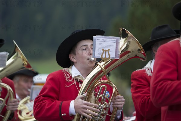 Brass player of the Weissensee marching band in traditional costume performing at the Naturparkfest festival in Techendorf