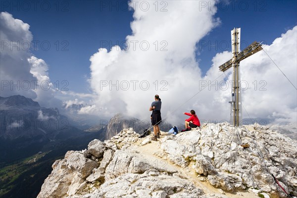 Hikers on the summit of Sasshongher mountain above Corvara