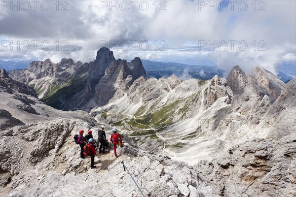 Climbers climbing Kesselkogel mountain via the fixed rope route above the Grasleitenpass