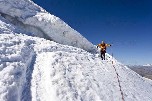 Hiker standing next to a crevasse