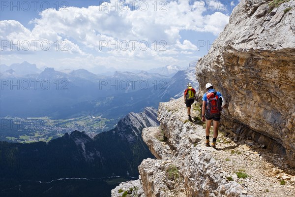 Mountain climbers descending down the Via Ferrata Ivano Dibona climbing route on the summit of Cristallino on Monte Cristallo