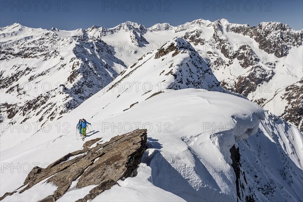 Ski walkers on the summit ridge with snowdrift