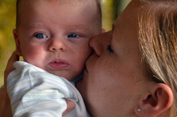 Young mother caressing an infant