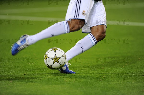 Real Madrid player running after the official match ball