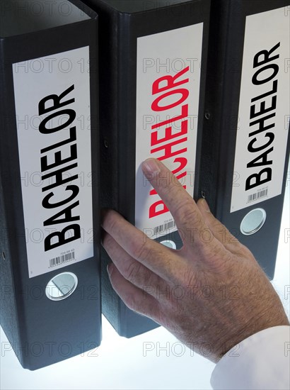 Hand reaching for a file folder labeled "Bachelor"