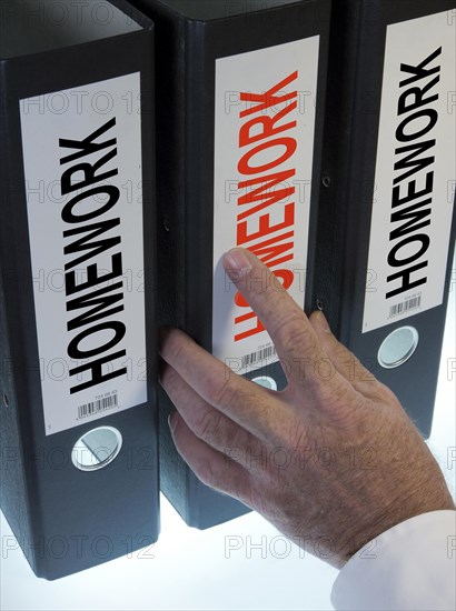 Hand reaching for a file folder labeled 'Homework'